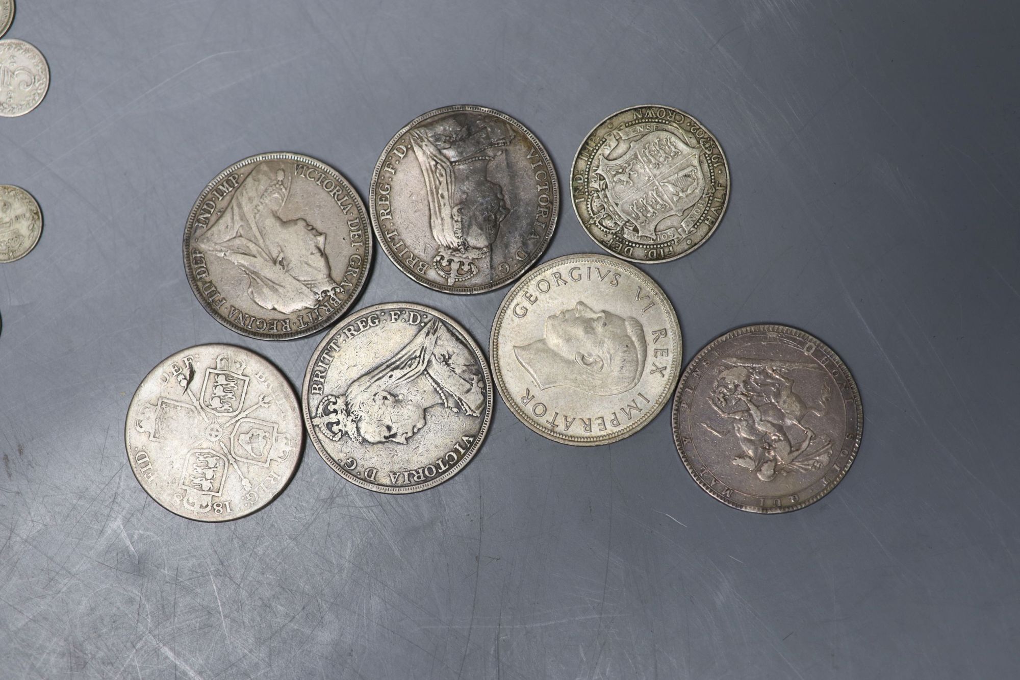 A collection of UK and world coins including George IV - George V silver threepences to halfcrowns